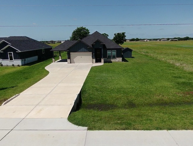 535 Longhorn Trl, Angleton, TX 77515 - view of front facade featuring driveway, a front lawn, an attached garage, and board and batten siding
