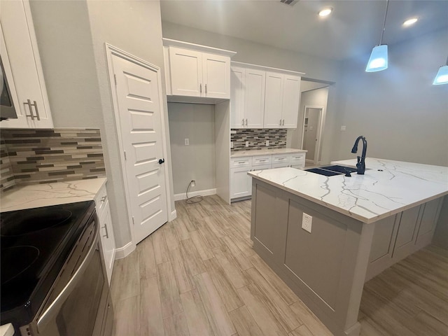 535 Longhorn Trl, Angleton, TX 77515 - kitchen with a sink, range, light wood-style floors, tasteful backsplash, and white cabinets