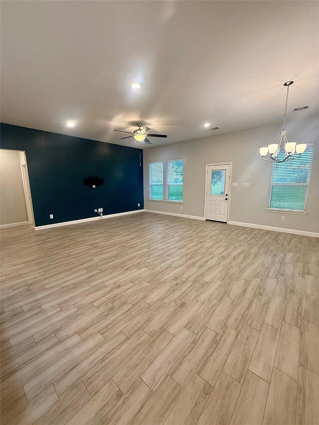 535 Longhorn Trl, Angleton, TX 77515 - unfurnished living room featuring light wood-style floors, baseboards, a ceiling fan, a chandelier, and recessed lighting