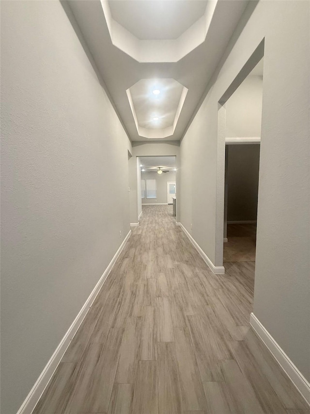 535 Longhorn Trl, Angleton, TX 77515 - hall featuring a raised ceiling, wood finished floors, and baseboards