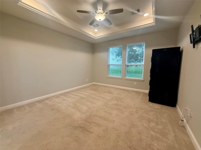 535 Longhorn Trl, Angleton, TX 77515 - empty room featuring a tray ceiling, light colored carpet, ceiling fan, and baseboards