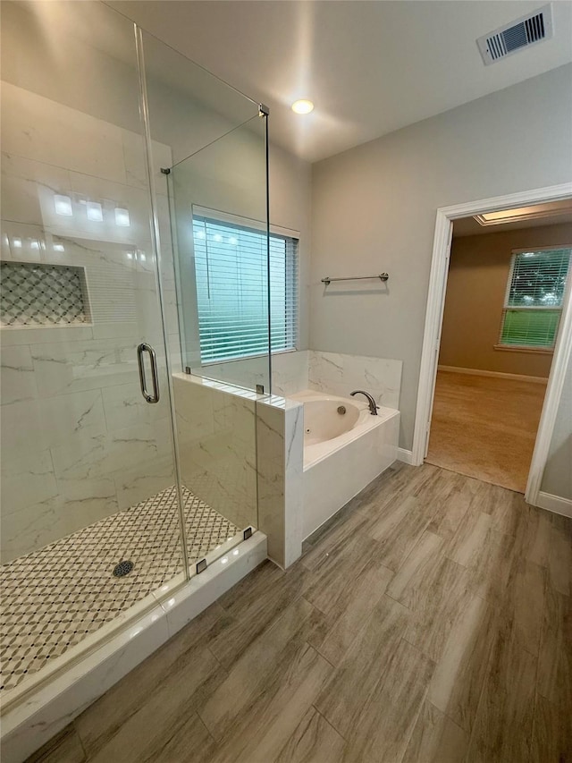 535 Longhorn Trl, Angleton, TX 77515 - full bathroom featuring a garden tub, a marble finish shower, wood finished floors, and baseboards