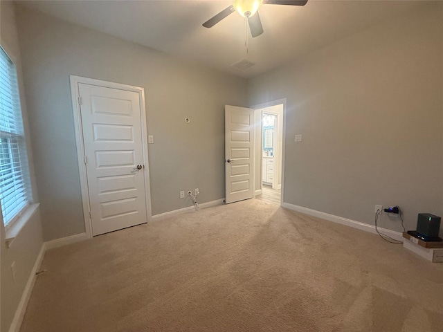 535 Longhorn Trl, Angleton, TX 77515 - unfurnished bedroom featuring light carpet, a ceiling fan, and baseboards