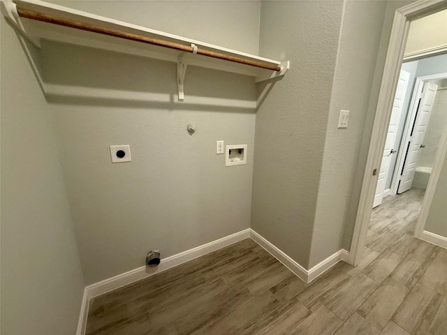 535 Longhorn Trl, Angleton, TX 77515 - laundry room featuring wood finished floors, hookup for an electric dryer, washer hookup, baseboards, and hookup for a gas dryer