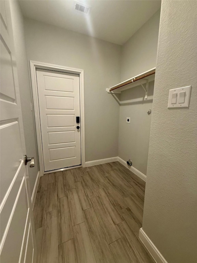 535 Longhorn Trl, Angleton, TX 77515 - washroom with electric dryer hookup, wood finished floors, and baseboards