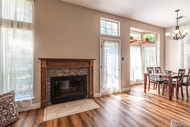 20423 Lone Star Oak St, Cypress, TX 77433 - dining space featuring a chandelier, wood finished floors, a stone fireplace, and baseboards