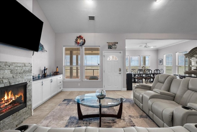 7014 Terrasso Dr, Hitchcock, TX 77563 - living area with light tile patterned flooring, a stone fireplace, a ceiling fan, and baseboards
