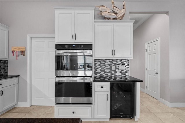 7014 Terrasso Dr, Hitchcock, TX 77563 - kitchen featuring double oven, beverage cooler, dark countertops, and light tile patterned floors