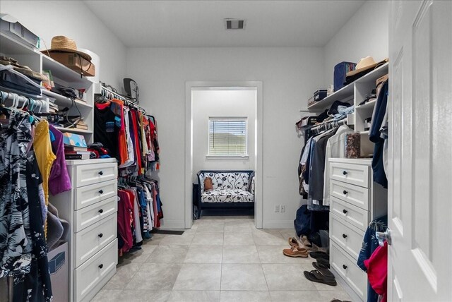 7014 Terrasso Dr, Hitchcock, TX 77563 - walk in closet featuring light tile patterned floors