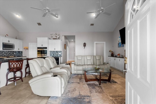 7014 Terrasso Dr, Hitchcock, TX 77563 - living area featuring a ceiling fan, vaulted ceiling, and light tile patterned flooring