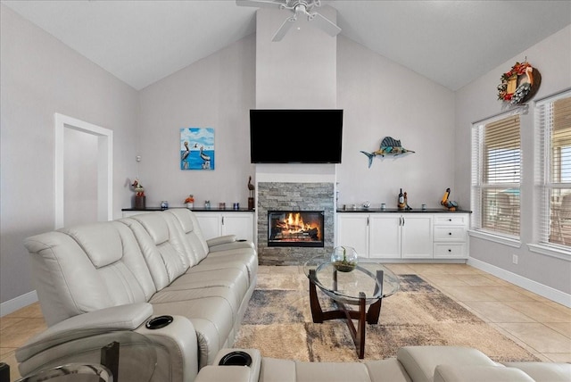 7014 Terrasso Dr, Hitchcock, TX 77563 - living room with high vaulted ceiling, light tile patterned floors, baseboards, a stone fireplace, and a ceiling fan