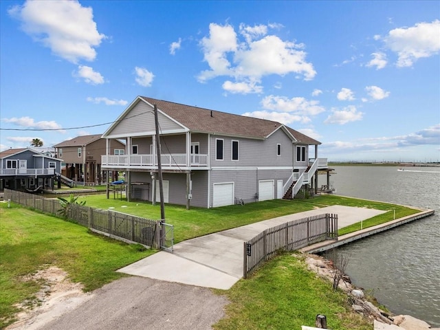 7014 Terrasso Dr, Hitchcock, TX 77563 - back of property with a garage, driveway, stairs, and a deck with water view