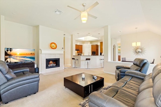 3502 Barrington Ct, Pearland, TX 77584 - living room featuring light carpet, a ceiling fan, and a tile fireplace