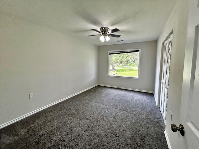 827 Live Oak Dr, Jones Creek, TX 77541 - unfurnished bedroom featuring dark colored carpet, baseboards, a closet, and a ceiling fan