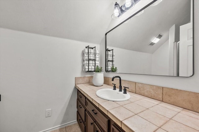 9819 Crestwater Cir, Magnolia, TX 77354 - bathroom with lofted ceiling, vanity, and tile patterned flooring