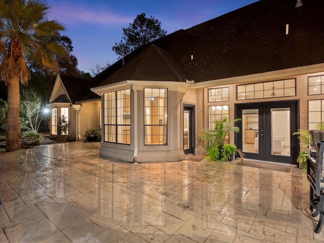 9819 Crestwater Cir, Magnolia, TX 77354 - exterior entry at dusk with french doors