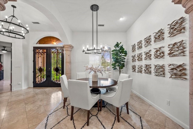 9819 Crestwater Cir, Magnolia, TX 77354 - dining area featuring a chandelier, french doors, arched walkways, baseboards, and light tile patterned floors