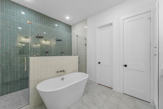 1316 E 34th St, Houston, TX 77022 - bathroom featuring a walk in shower, a freestanding tub, and recessed lighting