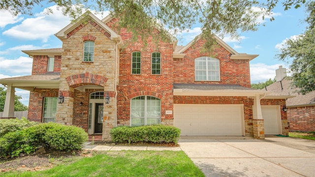 4403 Bridgestone Cedar Dr, Spring, TX 77388 - view of front of home featuring driveway, brick siding, a garage, and stone siding