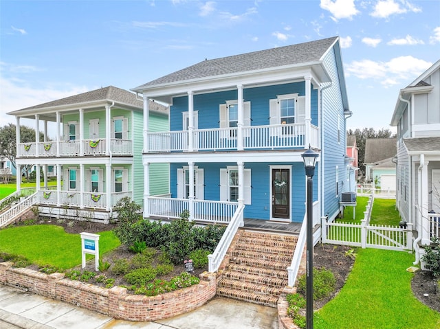 11 Caravelle Ct, Galveston, TX 77554 - view of front of home featuring a porch, stairs, and a balcony