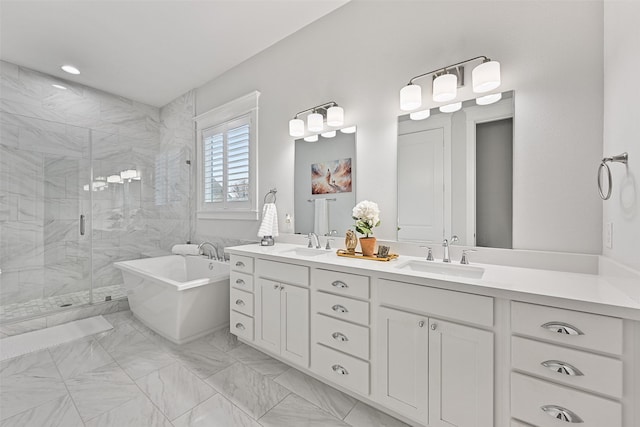 11 Caravelle Ct, Galveston, TX 77554 - full bathroom with a soaking tub, double vanity, a shower stall, and marble finish flooring