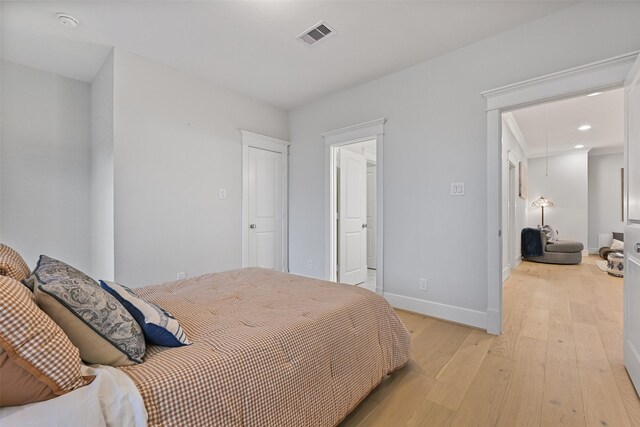11 Caravelle Ct, Galveston, TX 77554 - bedroom with light wood-style floors, baseboards, recessed lighting, and attic access