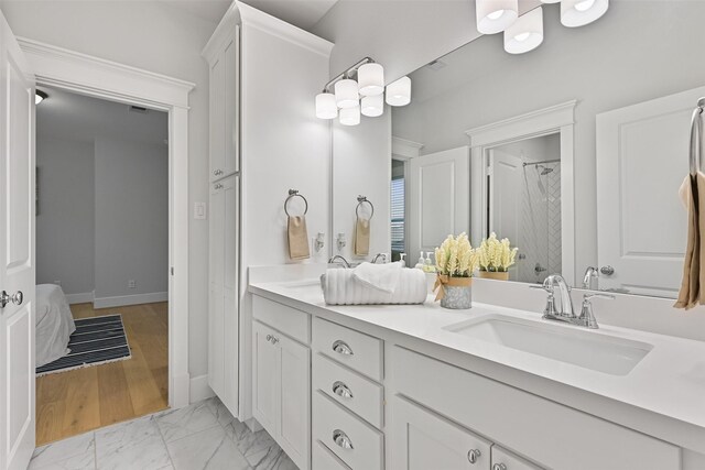 11 Caravelle Ct, Galveston, TX 77554 - full bath featuring double vanity, marble look tiles, a shower, and baseboards