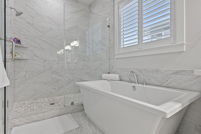11 Caravelle Ct, Galveston, TX 77554 - bathroom with a shower stall, a soaking tub, and marble finish flooring