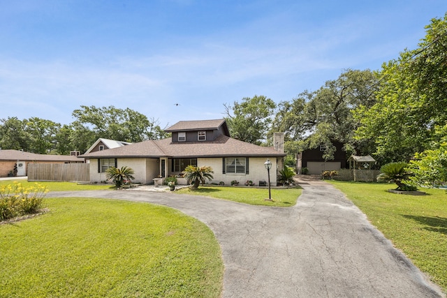16219 Dundee Rd, Cypress, TX 77429 - view of front of home featuring curved driveway, a chimney, and roof with shingles