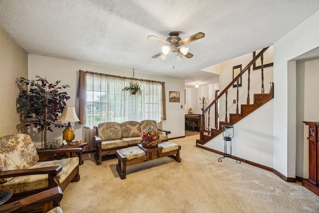 16219 Dundee Rd, Cypress, TX 77429 - living room with light carpet, stairs, a ceiling fan, a textured ceiling, and baseboards