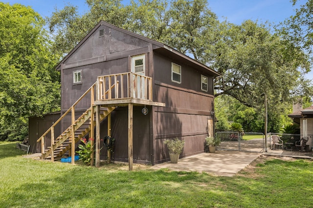 16219 Dundee Rd, Cypress, TX 77429 - back of property featuring a gate, stairway, and a deck