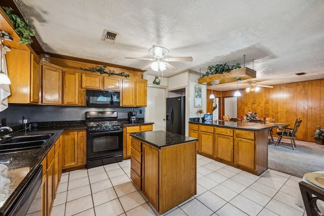 16219 Dundee Rd, Cypress, TX 77429 - kitchen featuring black appliances, ceiling fan, a sink, brown cabinets, and a kitchen island