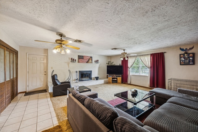 16219 Dundee Rd, Cypress, TX 77429 - living area with a fireplace, a textured ceiling, ceiling fan, and light tile patterned flooring