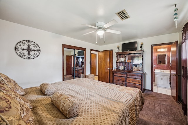 16219 Dundee Rd, Cypress, TX 77429 - bedroom with tile patterned flooring, ensuite bathroom, carpet flooring, and ceiling fan