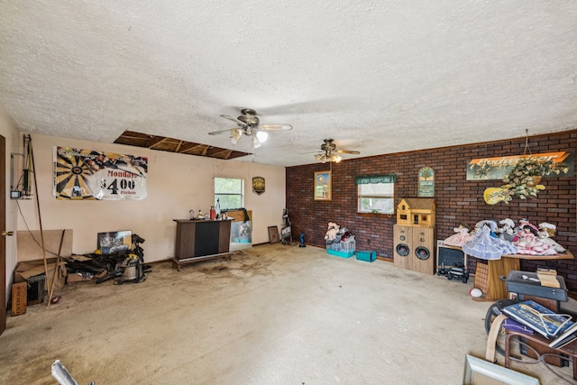 16219 Dundee Rd, Cypress, TX 77429 - carpeted living room with a textured ceiling, a ceiling fan, and brick wall