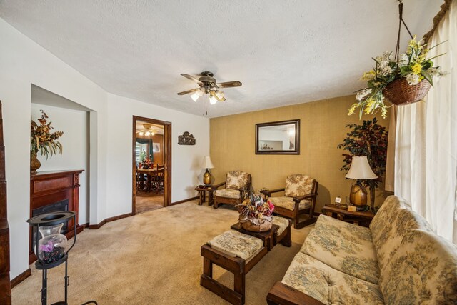 16219 Dundee Rd, Cypress, TX 77429 - living room with light carpet, a ceiling fan, baseboards, and a textured ceiling