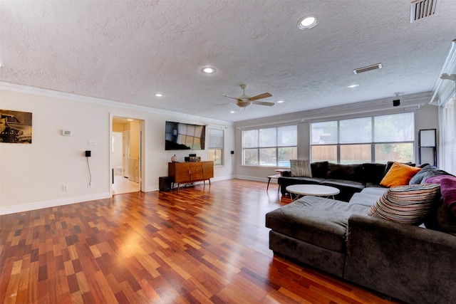 5638 Long Creek Ln, Houston, TX 77088 - living room with ornamental molding, ceiling fan, wood finished floors, a textured ceiling, and baseboards