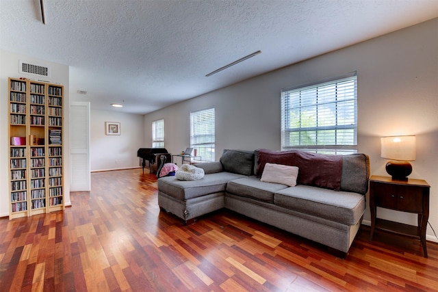5638 Long Creek Ln, Houston, TX 77088 - living room with a textured ceiling, wood finished floors, and baseboards