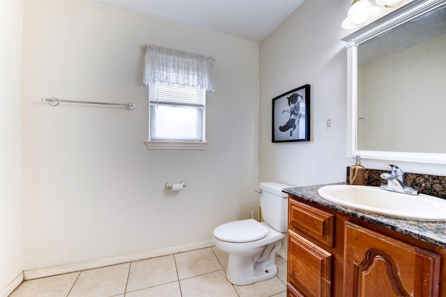 5638 Long Creek Ln, Houston, TX 77088 - bathroom featuring toilet, vanity, tile patterned flooring, and baseboards