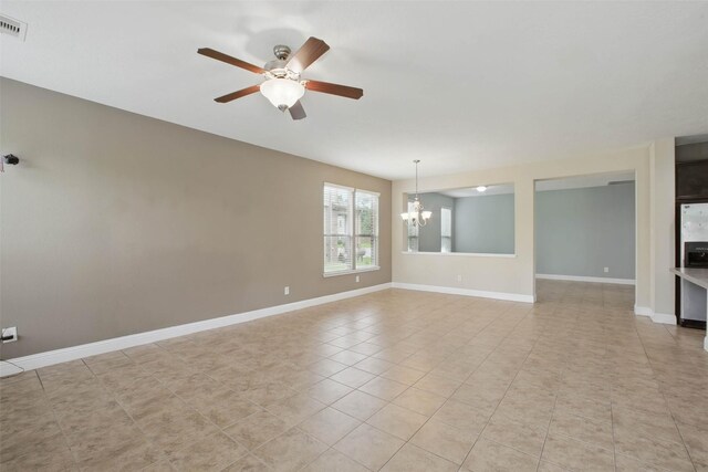 11707 Newel Elm St, Houston, TX 77038 - empty room with a chandelier, a ceiling fan, light tile patterned floors, and baseboards