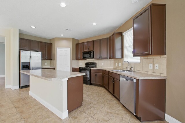 11707 Newel Elm St, Houston, TX 77038 - kitchen featuring black appliances, a sink, decorative backsplash, light countertops, and recessed lighting