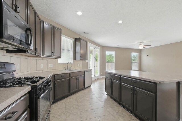 11707 Newel Elm St, Houston, TX 77038 - kitchen with black appliances, a sink, a ceiling fan, decorative backsplash, and a kitchen island