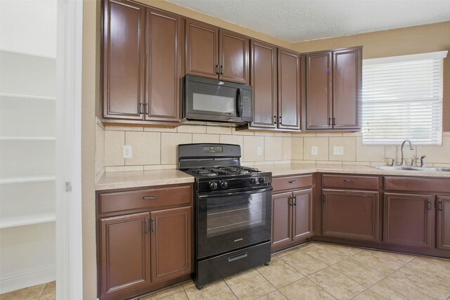 11707 Newel Elm St, Houston, TX 77038 - kitchen featuring black appliances, a sink, light countertops, and tasteful backsplash