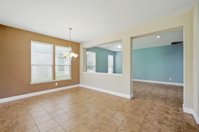 11707 Newel Elm St, Houston, TX 77038 - unfurnished room with a chandelier, light tile patterned floors, and baseboards