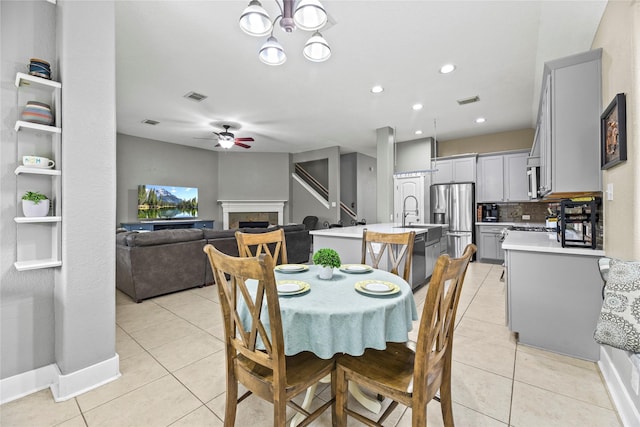 20918 Field Manor Ln, Katy, TX 77450 - dining area featuring light tile patterned floors, ceiling fan, a fireplace, and recessed lighting