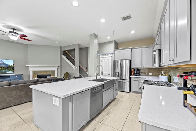 20918 Field Manor Ln, Katy, TX 77450 - kitchen with stainless steel appliances, light tile patterned floors, gray cabinets, a sink, and recessed lighting