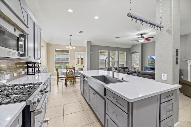 20918 Field Manor Ln, Katy, TX 77450 - kitchen featuring gray cabinetry, appliances with stainless steel finishes, a sink, ceiling fan, and light tile patterned flooring