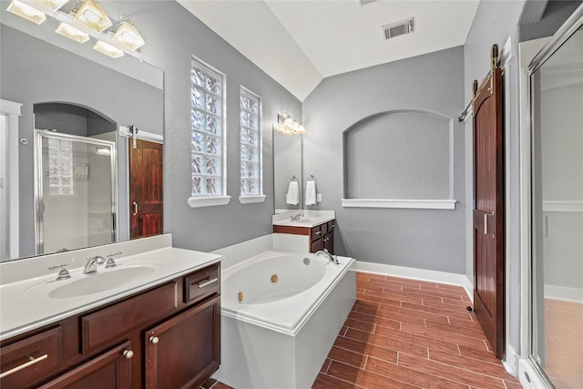 20918 Field Manor Ln, Katy, TX 77450 - full bath featuring a shower stall, two vanities, a tub with jets, wood finished floors, and vaulted ceiling