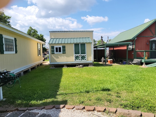 639 Manor St, Houston, TX 77015 - rear view of house with an outdoor structure, a lawn, and metal roof