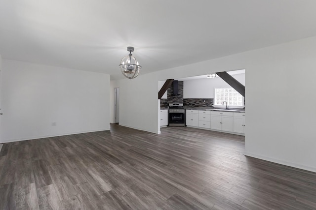 639 Manor St, Houston, TX 77015 - unfurnished living room featuring a chandelier, dark wood finished floors, a sink, and baseboards